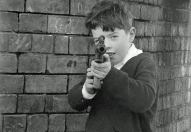 Boy playing with a toy gun on Bombay Street  (1970)