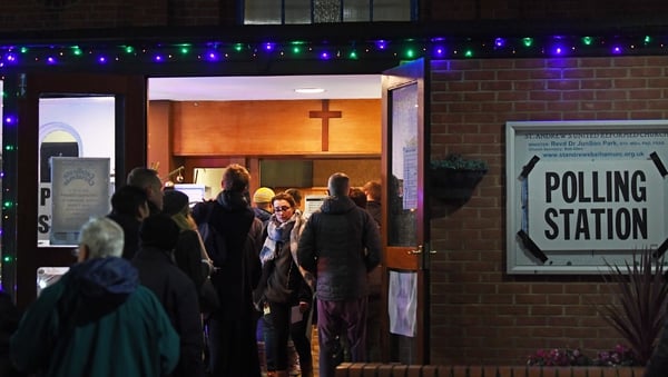 Voters queue outside St Andrews Church polling station in Balham, south London, this evening