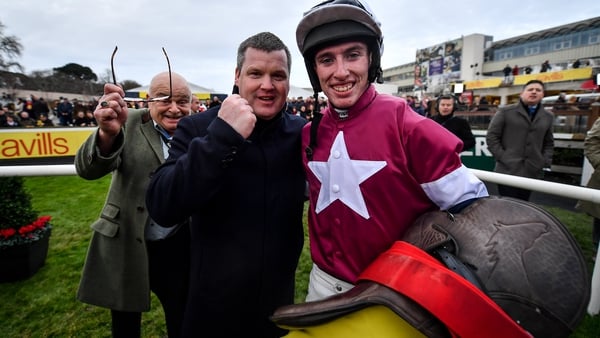 Jack Kennedy (R) celebrates with trainer Gordon Elliott (C) after riding Delta Work to win the Savills Chase