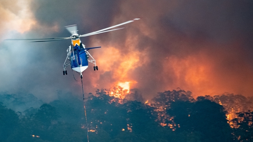 A firefighting helicopter tackles a bushfire near Bairnsdale in Victoria's East Gippsland region