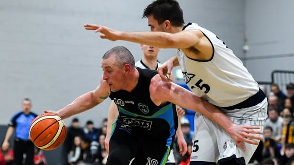 Kieran Donaghy of Garvey's Warriors Tralee in action against Marko Tomic of DBS Eanna