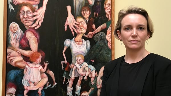Ireland Portrayed: Cristín Leach in front of Rita Duffy's painting Segregation (1989)