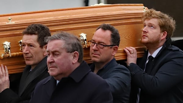 Marian Finucane's son Jack looks skyward as her coffin is carried into the church in Co Kildare