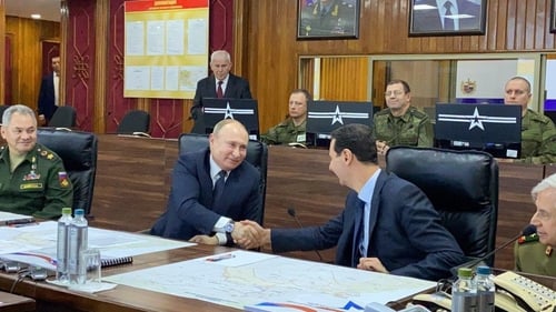 Vladimir Putin and Bashar al-Assad shaking hands in Damascus