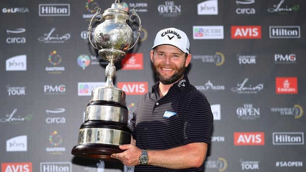 Branden Grace of South Africa celebrates with the trophy