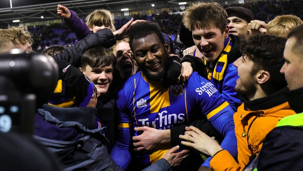 Aaron Pierre of Shrewsbury Town is mobbed by fans at the full-time whistle