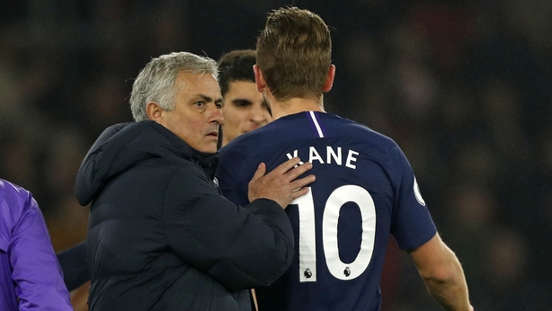 Harry Kane (R) as he leaves the pitch having picked up the injury