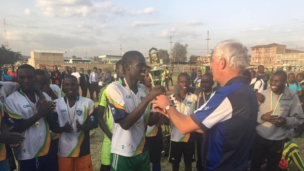 Kerryman Eddie Sheehy (R) presents the 'Eddie Sheehy Cup' to the winners of a soccer tournament in Embulbul, Kenya