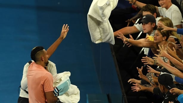 Kyrgios throws a towel to his fans after victory