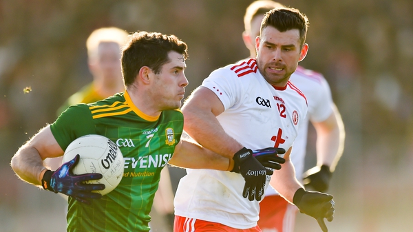 Donal Keogan of Meath (L)holds off Tyrone's Darren McCurry