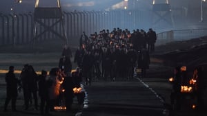 As night fell, survivors and dignitaries carried flickering candles as they walked along the railway that brought Jews from across Europe to the gas chambers