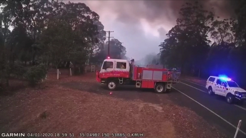 The crew quickly got into their vehicles and left the scene, moments before the road was engulfed in flames