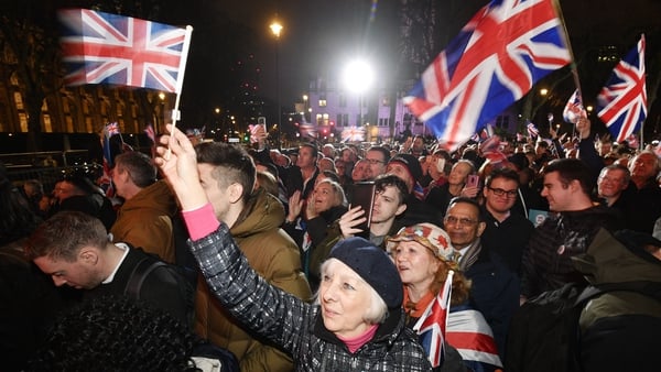 Pro Brexit supporters celebrate outside the Houses of Parliament in London