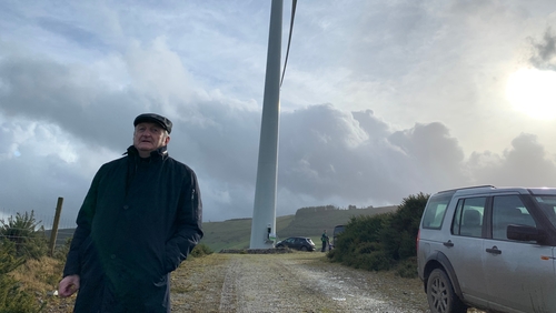 Co-founder John Fogarty in front of one of the two turbines
