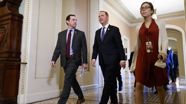 House impeachment managers Jason Crow (L) and Adam Schiff walk to the Senate chamber