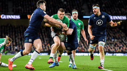 Scotland's Blair Kinghorn and Stuart Hogg attempt to stop a rampaging Andrew Conway