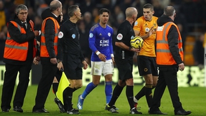 Conor Coady remonstrates with referee Mike Dean at Molineux
