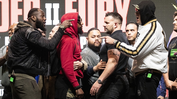 Deontay Wilder and Tyson Fury gesture after pushing each other on stage prior to their last press conference before their rematch in Las Vegas on Sunday morning