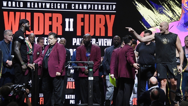 Tyson Fury (R) and Deontay Wilder were kept apart at last night's weigh-in