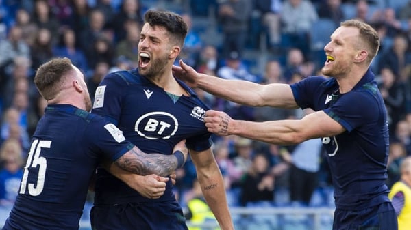 (L-R) Stuart Hogg, Adam Hastings and Rory Hutchison celebrate Scotland's third try
