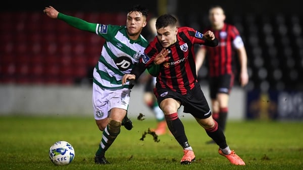 Alex Dunne of Shamrock Rovers II (L) and Longford's Aaron McNally battle for possession