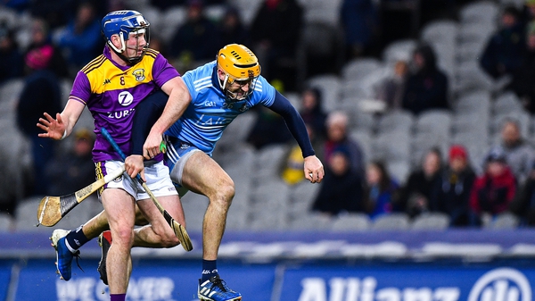 Liam Rushe of Dublin is tackled by Kevin Foley of Wexford