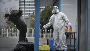 A worker disinfects a recovered COVID-19 patient departing a temporary hospital in Wuhan A worker disinfects a recovered COVID-19 patient departing a temporary hospital in Wuhan