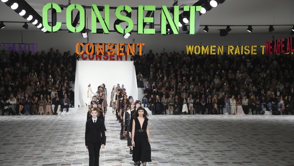 The show saw models walking beneath neon phrases saying 'Consent', and 'Patriarchy = Climate Emergency'.