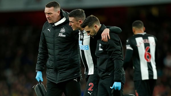 Irish defender Ciaran Clark (C) is helped from the pitch after picking up the injury