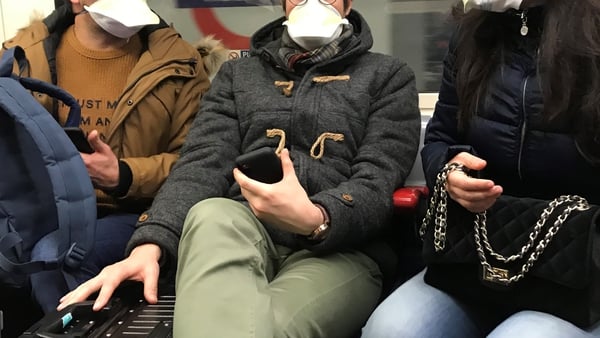 People on London's Tube wear face masks