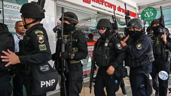 An armed police team entering the shopping complex earlier
