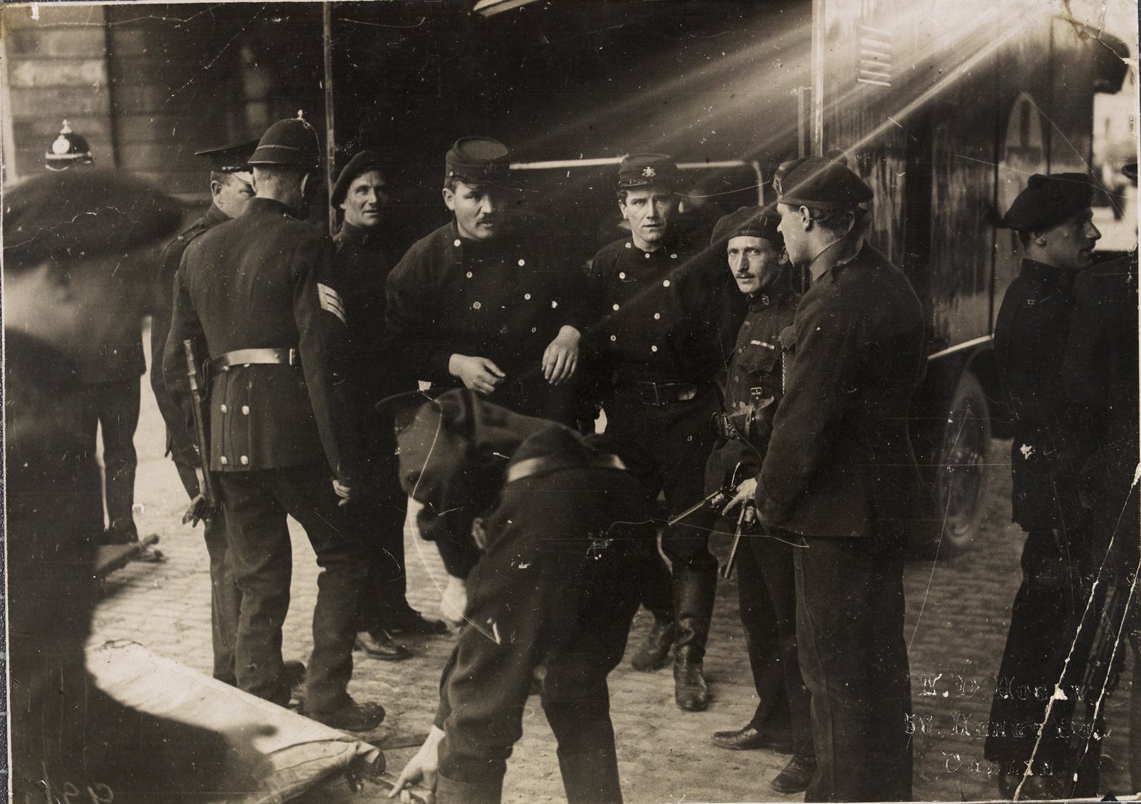 Image - Dublin Fire Brigade men remove the wounded after the IRA attack on the Custom House, Dublin. The armed men are Auxiliaries. Image courtesy of the National Library of Ireland