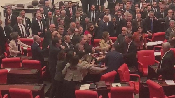 Dozens of parliamentarians joined the brawl, some climbing desks or throwing punches