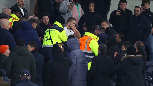 Eric Dier is ushered away by security at Tottenham Hotspur Stadium