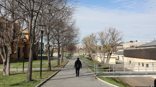 A university student walks alone in the empty campus of the Roma Tre University in Italy