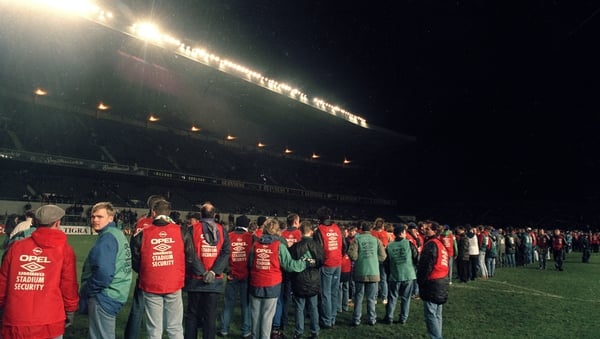 Stewards clear the pitch after rioting in Lansdowne Road's Upper West Stand caused the 1995 friendly to be abandoned