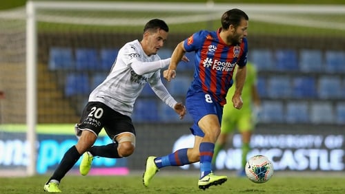 Newcastle Jets' Wes Hoolahan is pursued by Adrian Luna of Melbourne City