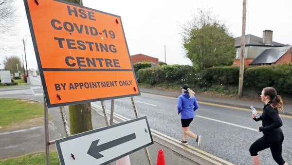 Runners pass a Covid-19 testing centre in Newbridge earlier this month. Photo: Niall Carson/PA Wire