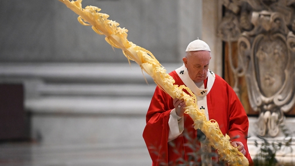 Pope Francis gathers his thoughts while holding a palm branch as he celebrates Palm Sunday