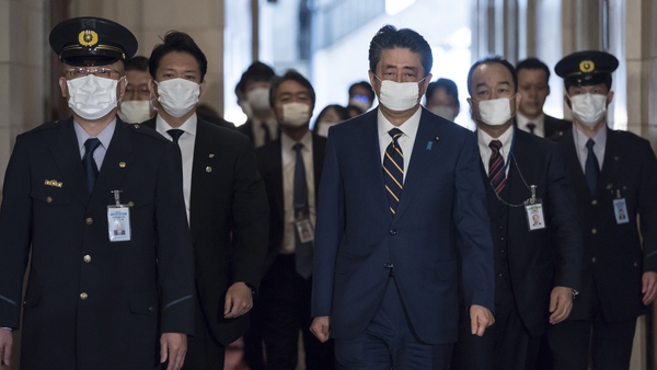 Shinzo Abe wearing a face mask, arrives for a committee meeting at the lower house of parliament in Tokyo