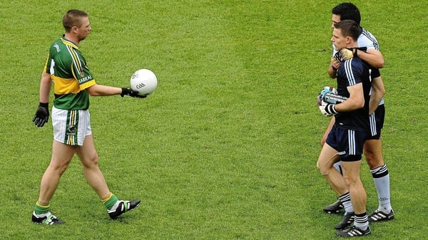 Tomas Ó Sé offers the match ball to Stephen Cluxton after the 2011 All-Ireland SFC final