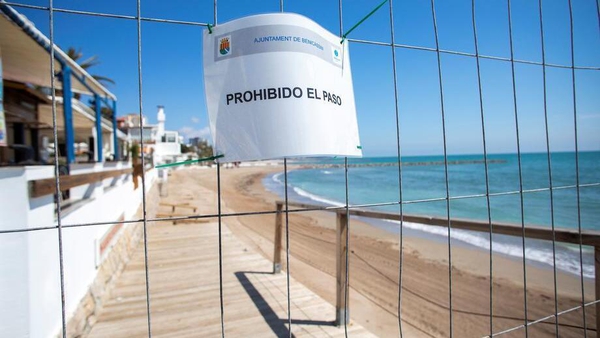 A fence and a 'no trespassing' sign seen at a beach in the coastal city of Benicassim, eastern Spain