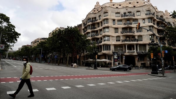 A man walks on a deserted street in Barcelona