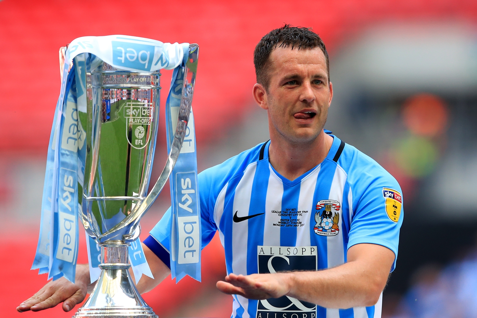 Image - Doyle with the League Two Play Off Final trophy in May 2018