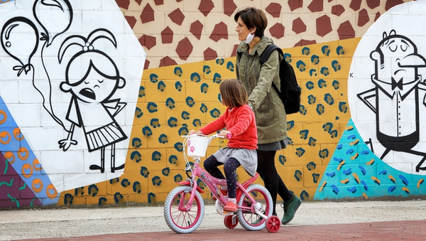 A mother and child out and about in Igualada, Spain, the first time minors have been allowed out in 44 days