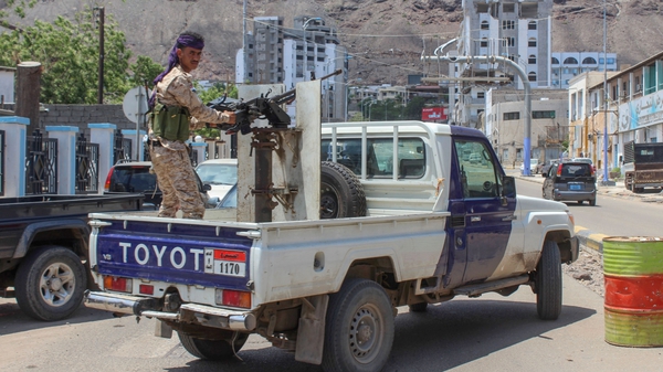 A fighter with Yemen's separatist Southern Transitional Council mans a gun in the back of a pick-up in Aden