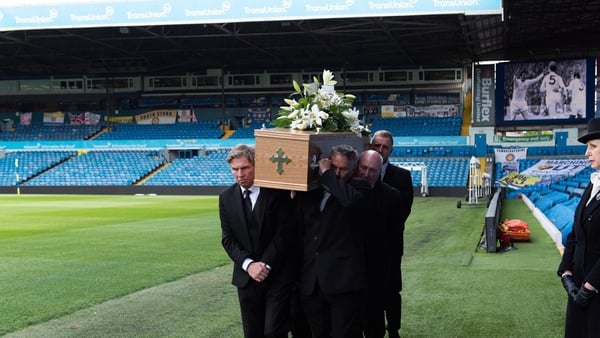 Norman Hunter's coffin is carried onto the pitch at Elland Road