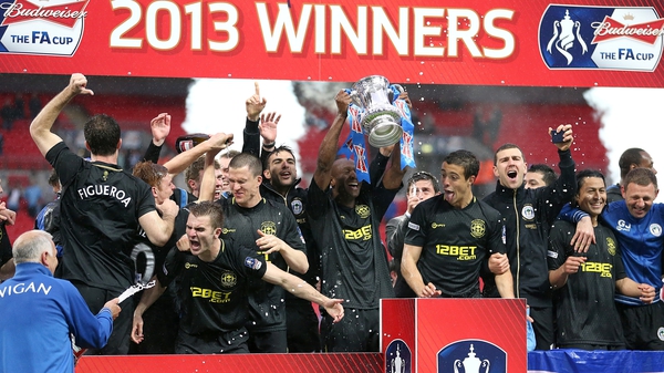 Wigan players celebrate a famous triumph