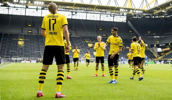 Erling Haland celebrates with teammates after giving Borussia Dortmund the lead against Schalke