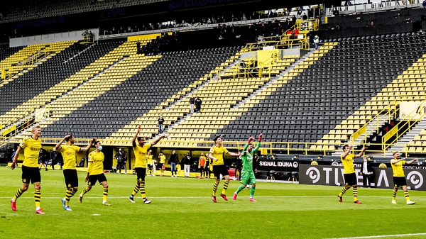 Dortmund players salute the empty stands after their 4-0 win over Schalke